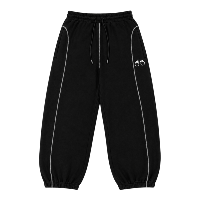 CROOKSLDN Black Convict Sweats, front view — baggy 550gsm brushed fleece joggers with white contrast piping, drawstring waist, elasticated cuffs and a small white handcuff logo.