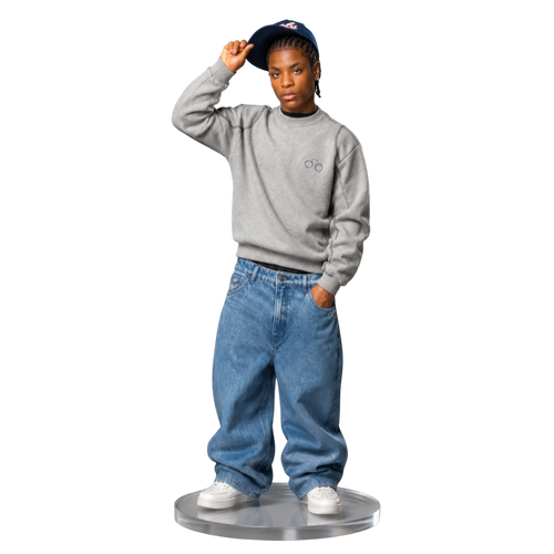 CROOKSLDN model wearing blue wash baggy OG jeans and a grey sweatshirt against a black background